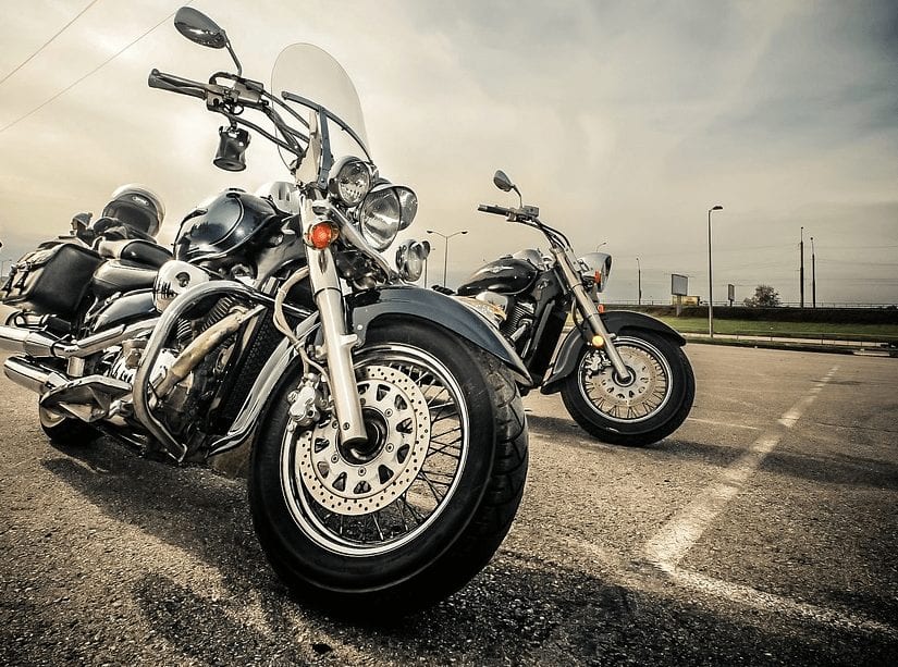 2 parked harley davidsons in a parking lot