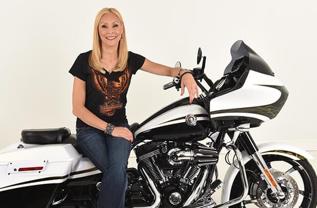 fran haasch sitting on a harley davidson that is black and white