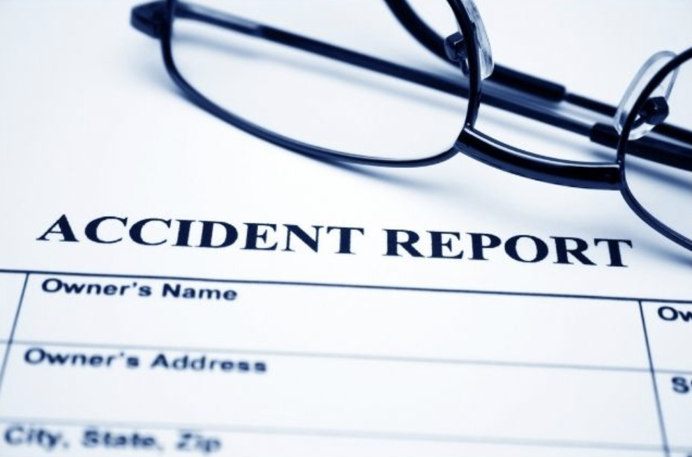 accident report piece of paper with glasses and forms to be filled out