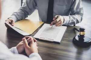 two people discussing a contract on a clipboard