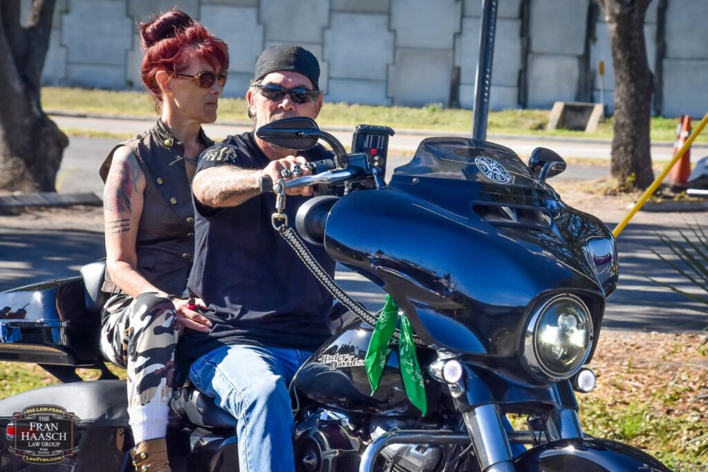 Is it Illegal to Ride a Motorcycle Without Insurance? two people riding a motorcycle in florida