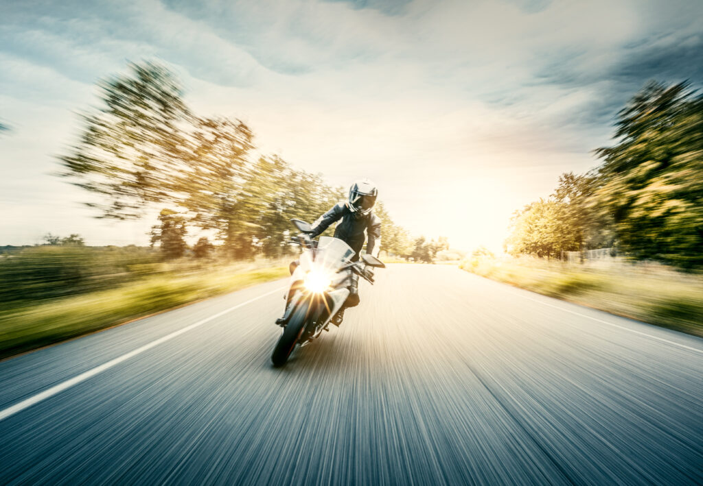 Woman drives an electric motorcycle on a country road in florida