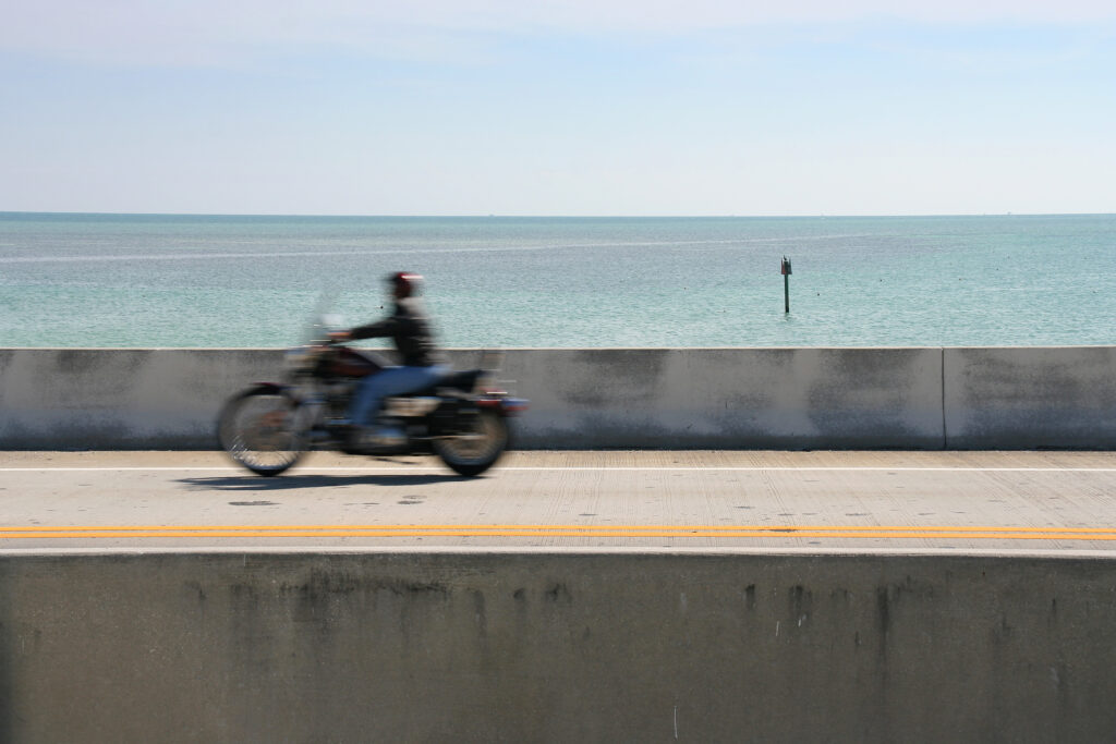 Biker on bridge between Florida Keys with a valid motorcycle license, motorcycle accidents in summer