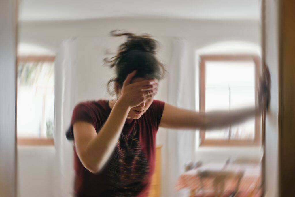 woman holding her forehead after an accident that has affected her mental health