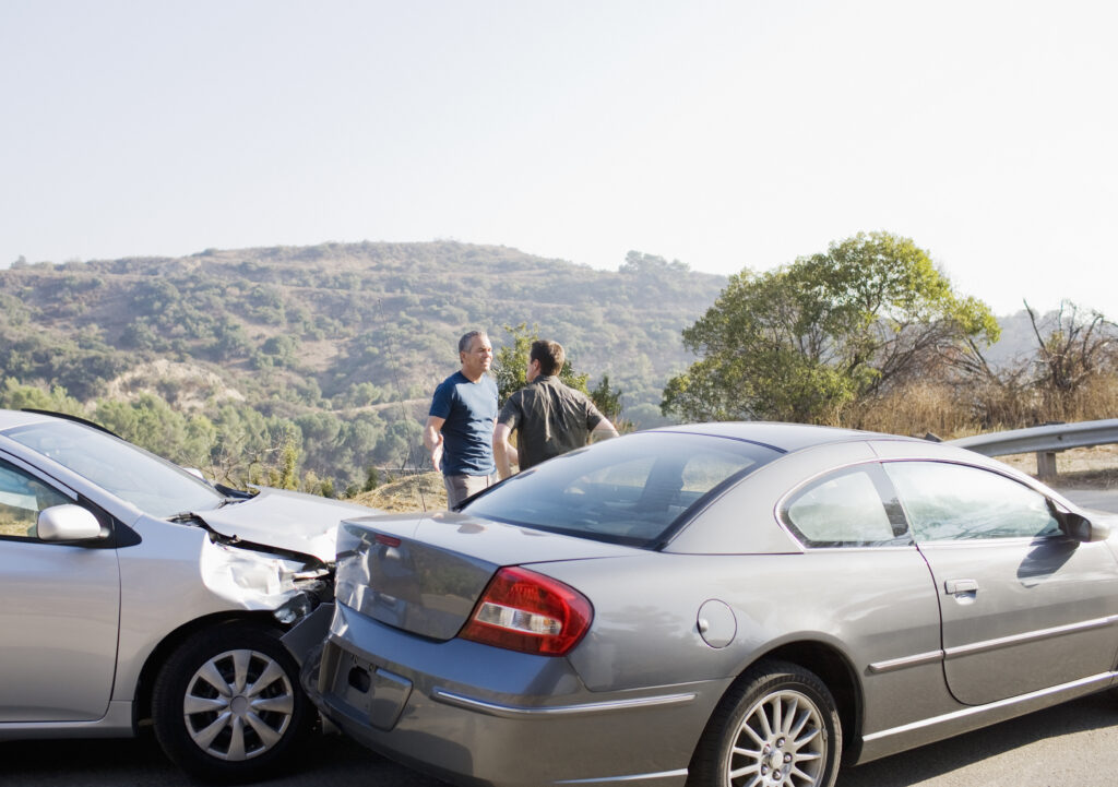 Two men arguing about damaged cars that are infront of them and vicarious liability