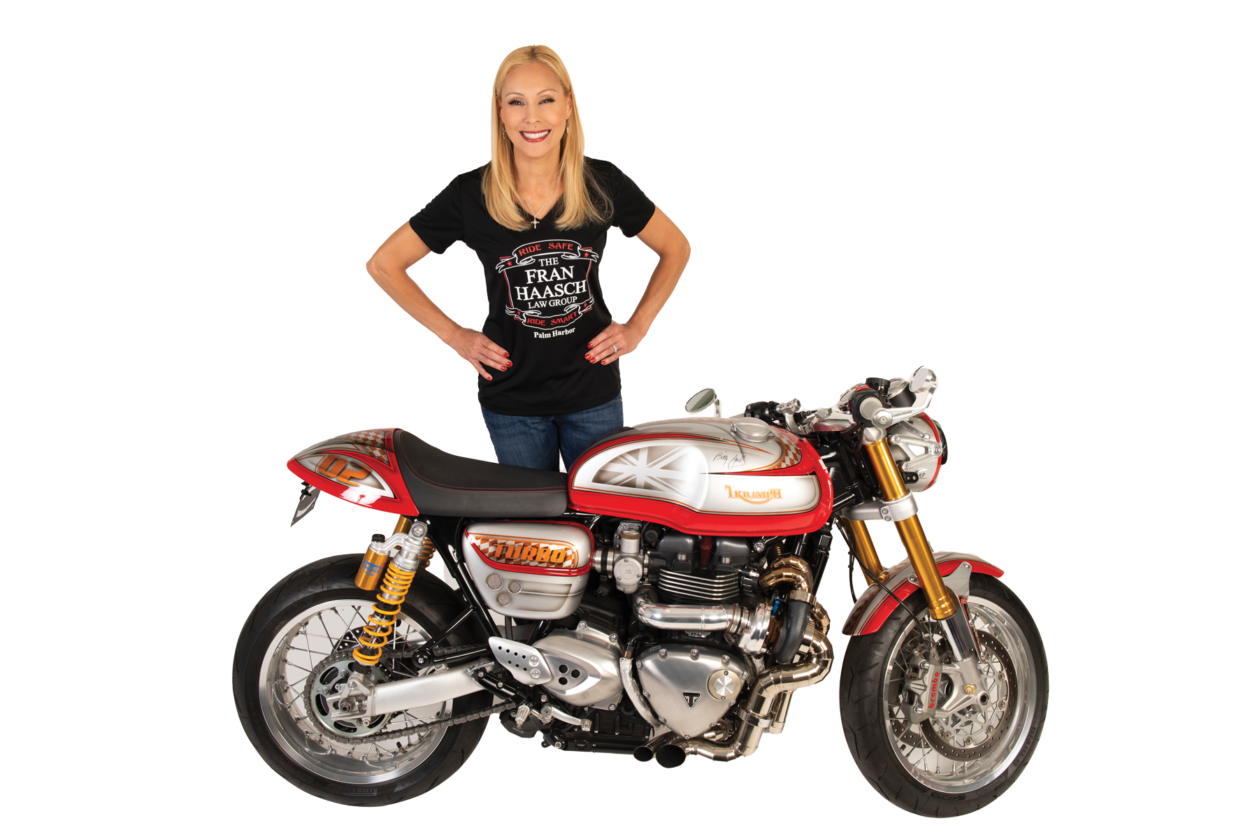 Fran Hasch standing behind a Triumph motorcycle