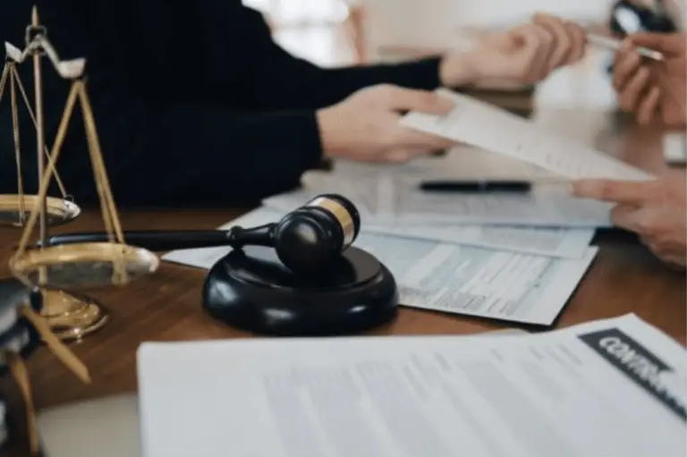 gavel, lawyer scale, personal injury lawyer handing a client a pen and forms