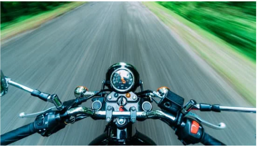 motorcycle driving down the road moving fast, point of view of the driver, helmet law in florida