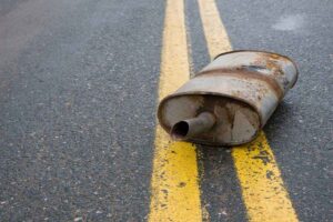 muffler in the middle of the road, road debris can cause damage