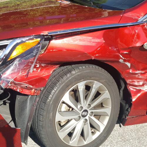 A vehicle with extensive front-end damage resulting from a car accident in Clearwater, Florida.