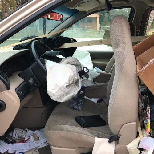 A Clearwater car accident scene showing the inside of one of the cars involved in the accident. Airbags are deployed and the seat is pushed forward.