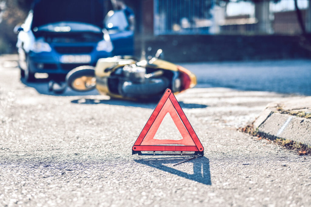 car motorcycle accident marked with a triangle on the side of the road
