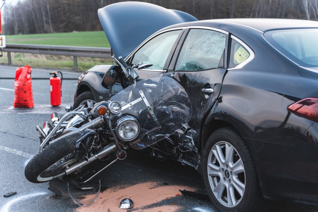 A damaged motorcycle and a car, on an asphalt road immediately after the accident in st petersburg