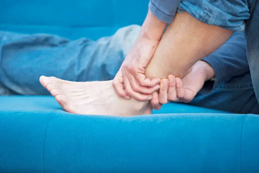hurting ankle after a personal injury accident, close up picture of man holding ankle