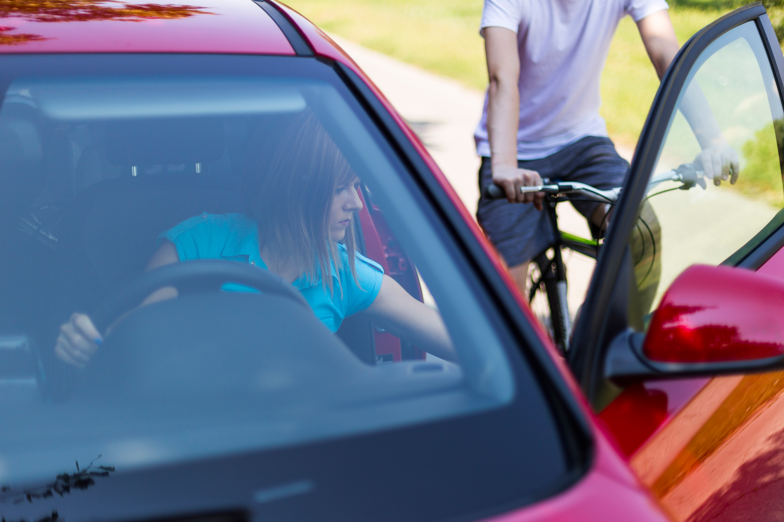 bike accident claim after a bicyclist runs into an open door, woman opening door and bicyclist in the way