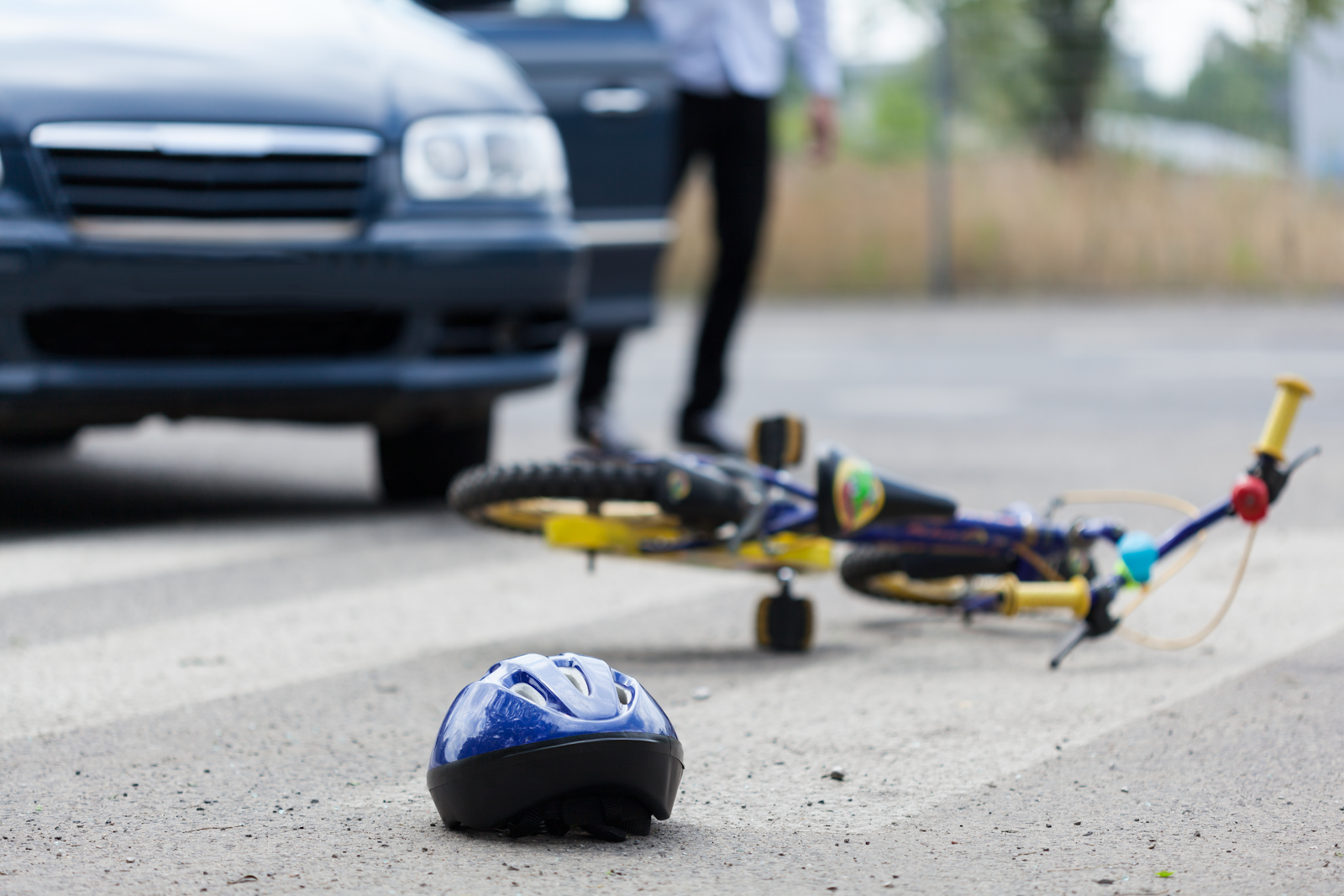 bicycle laying on the ground with a helmet next to it, st petersburg bicycle accident scene 