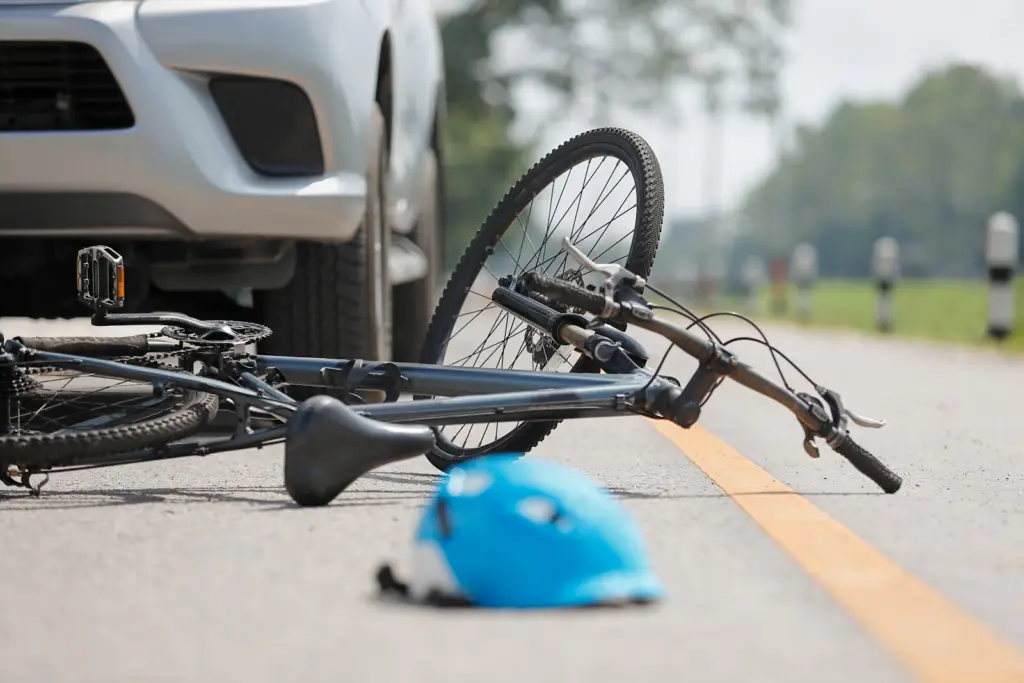 a bicycle laying on the road in front of the car that hit it, bicycle accident scene