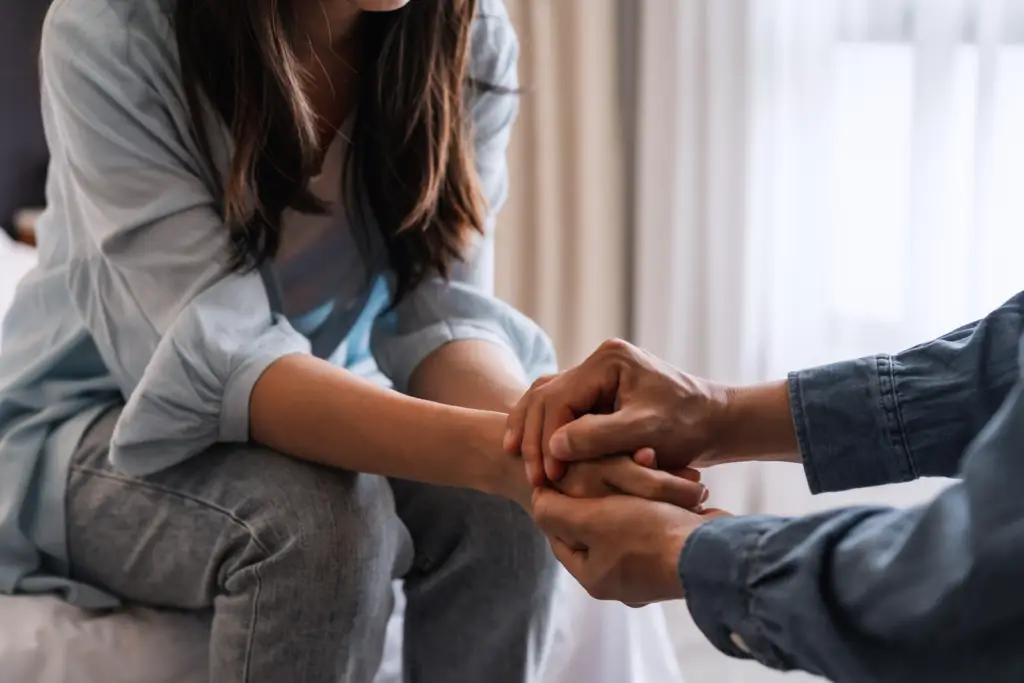 person holding the hands of the other comforting after a personal injury incident
