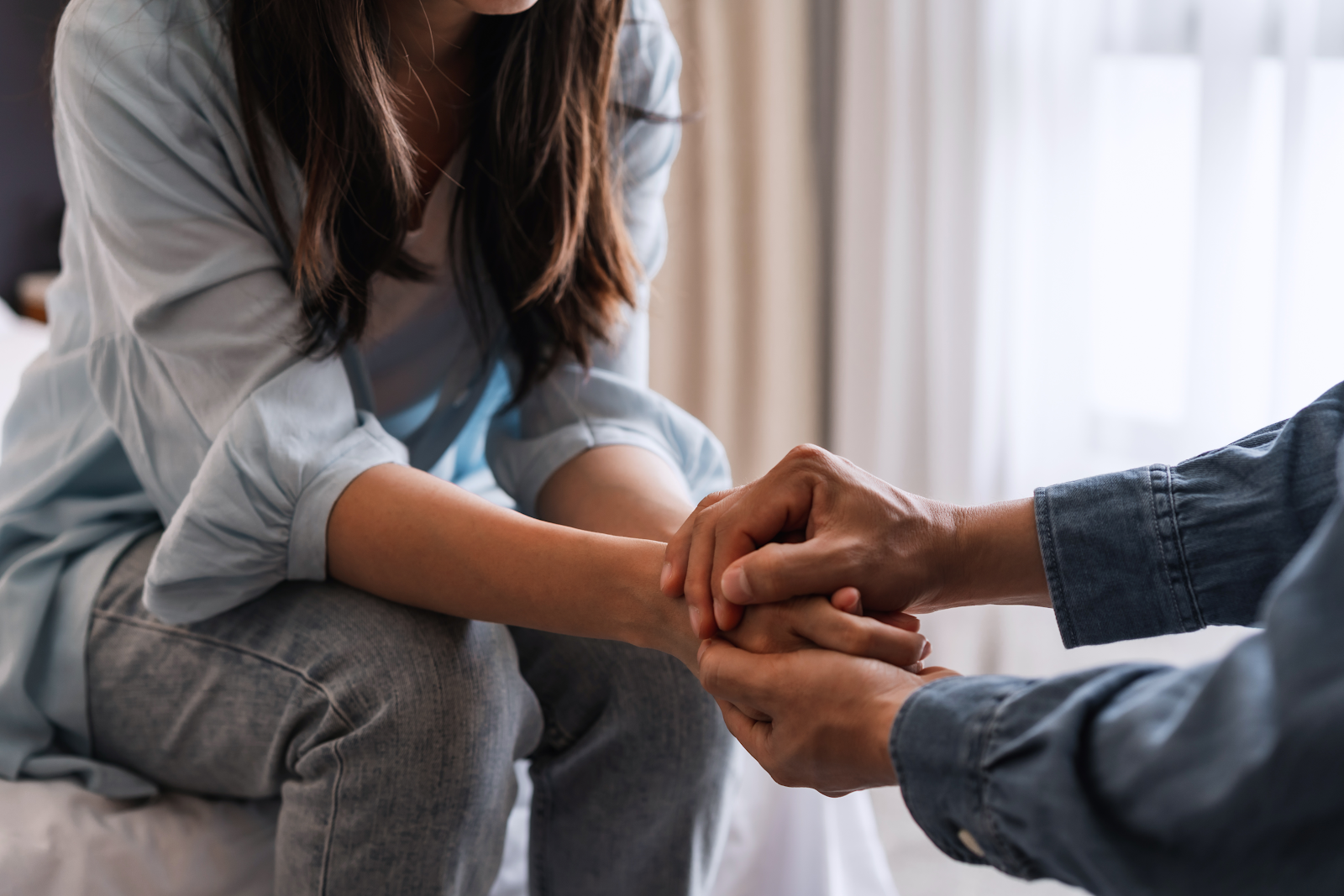 person holding anothers hand, comforting them after a fatal accident wrongful death 