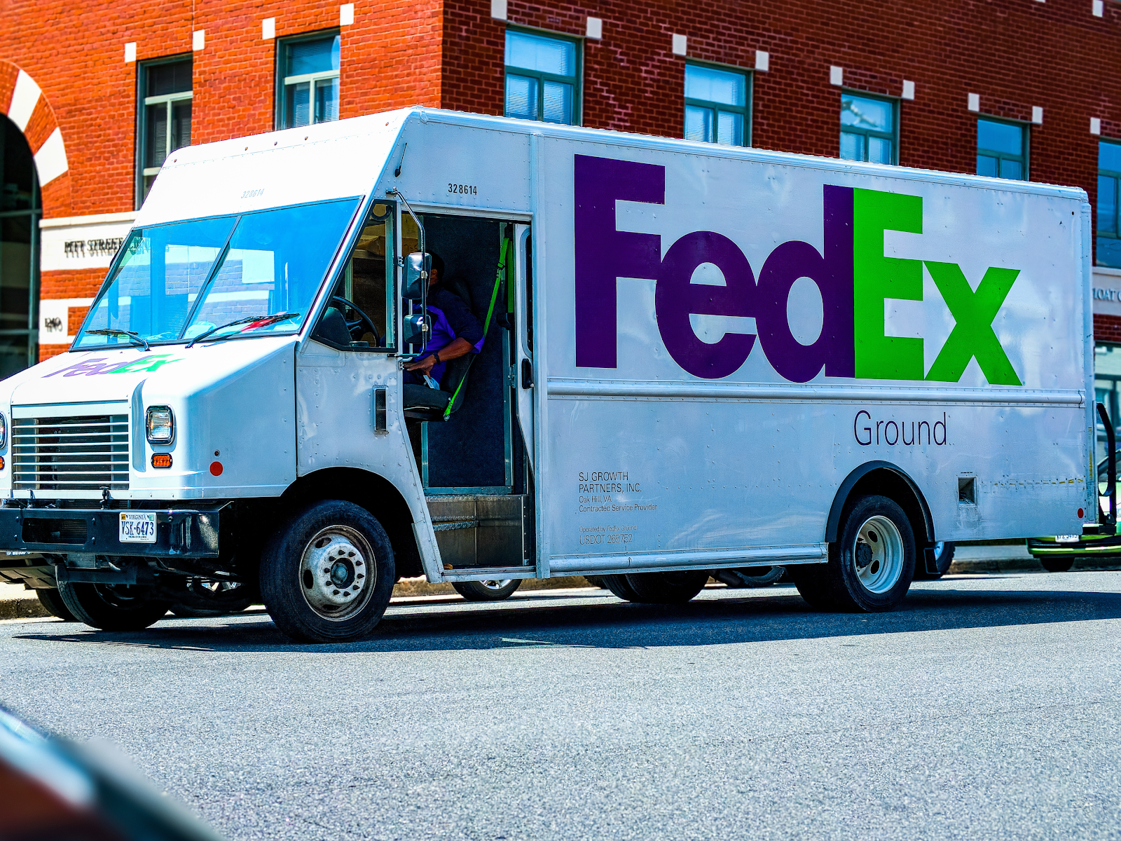fedex delivery truck on the road driving and making deliveries