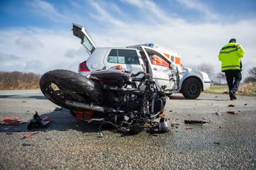 man walking away from a motorcycle accident with a car 