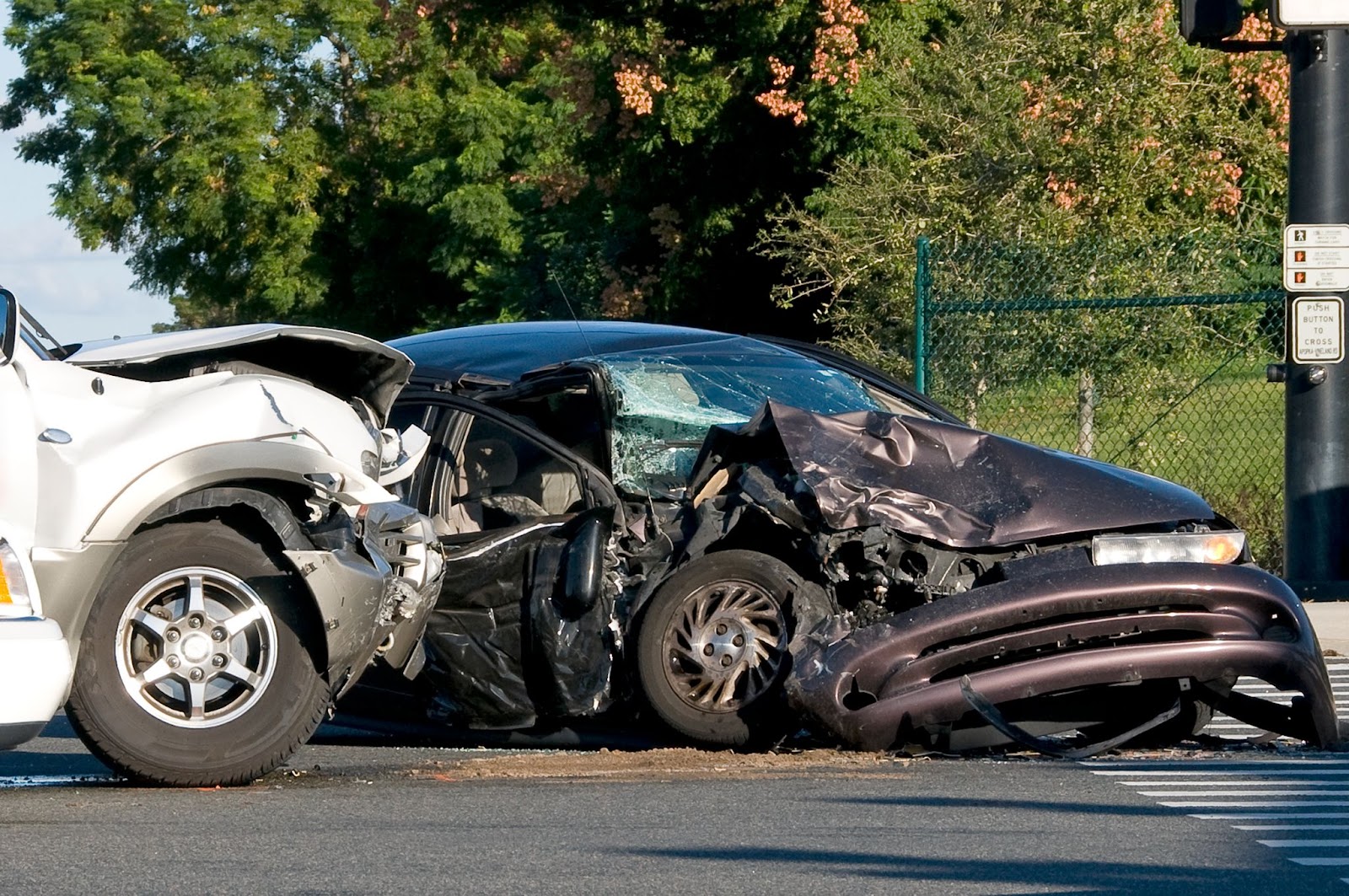 Two cars both show heavy damage after a high speed t-bone collision