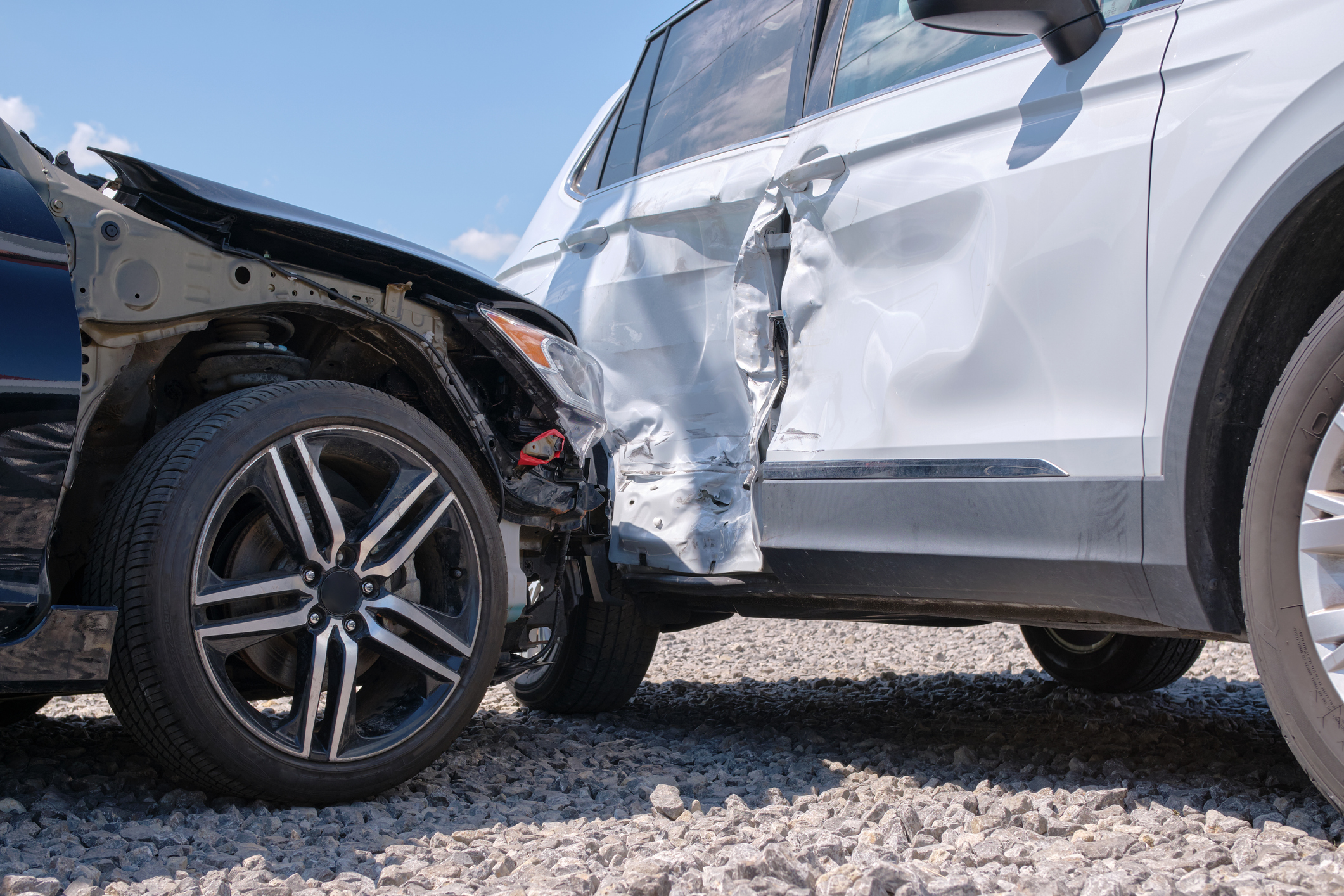 A close-up view of a T-Bone car accident that caused severe damage to both cars.