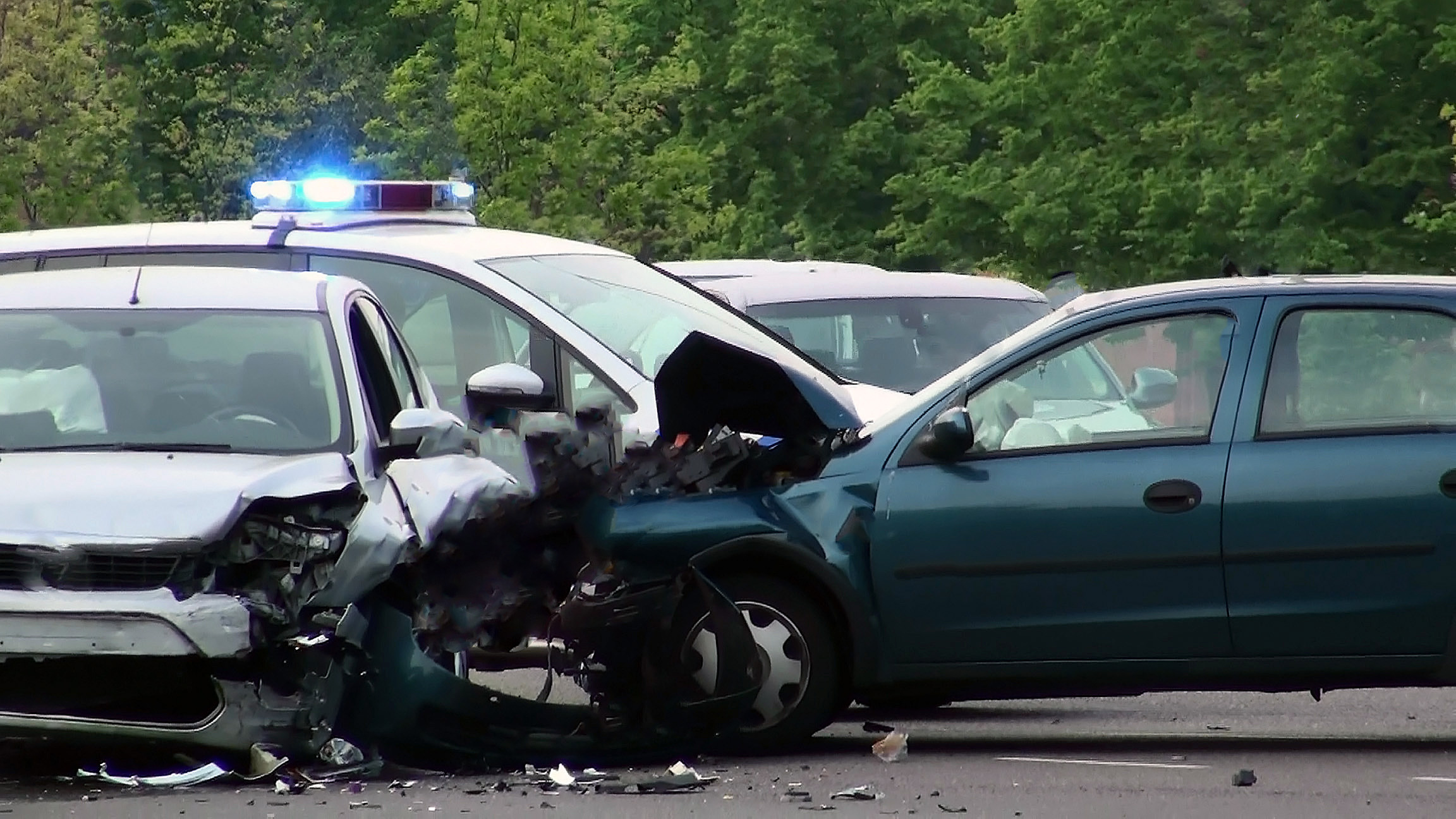 A side-impact collision at an intersection involving two cars with significant damage to both vehicles.
