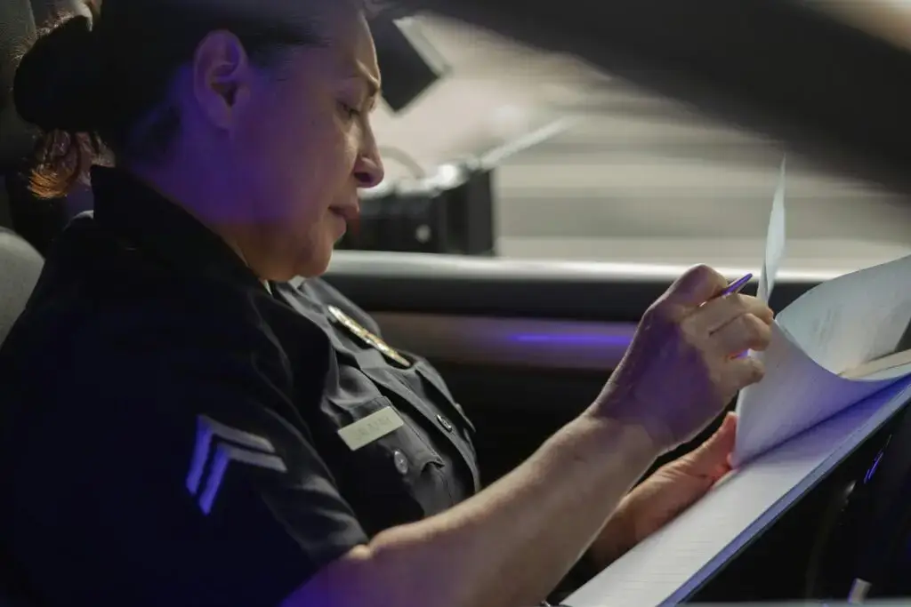 A female officer reviews the police report she is creating.