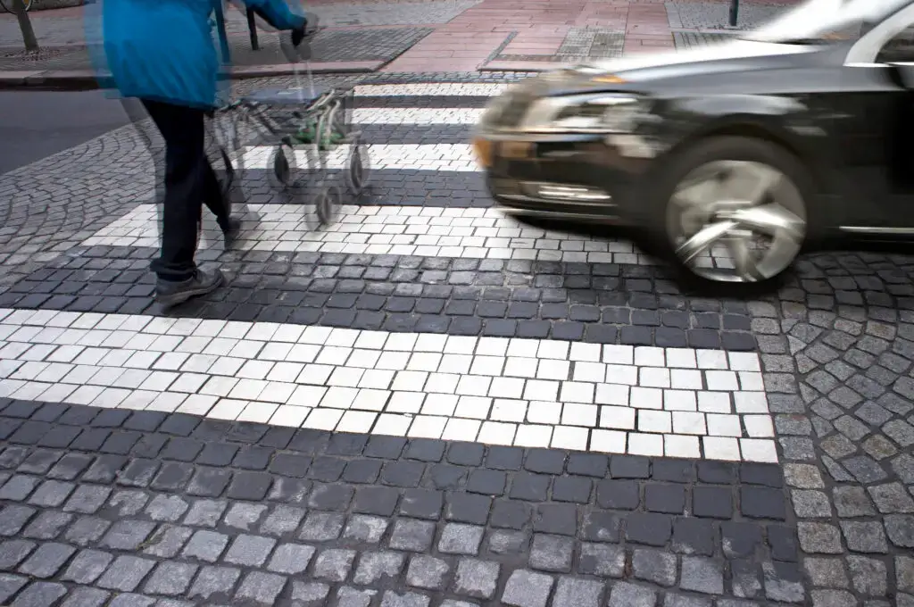 a senior citizen using a walker to cross the street is about to be struck by a motor vehicle passing through a crosswalk without yielding the right-of-way to the pedestrian, a violation of Florida pedestrian laws.