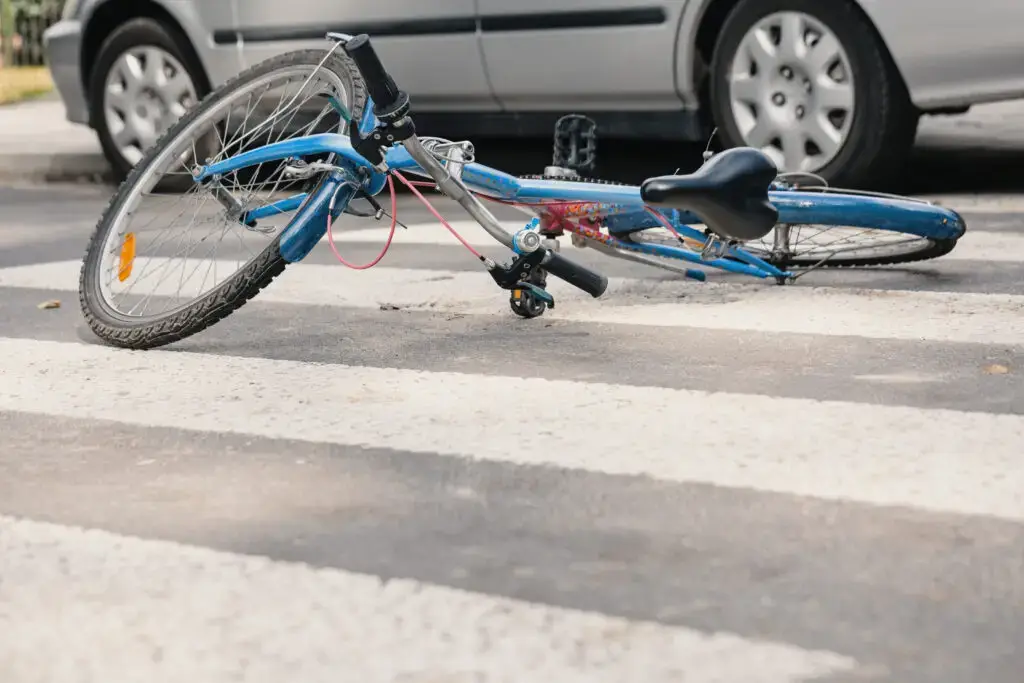 A mangled, blue bicycle sits in the middle of a crosswalk after an accident in Largo, Florida